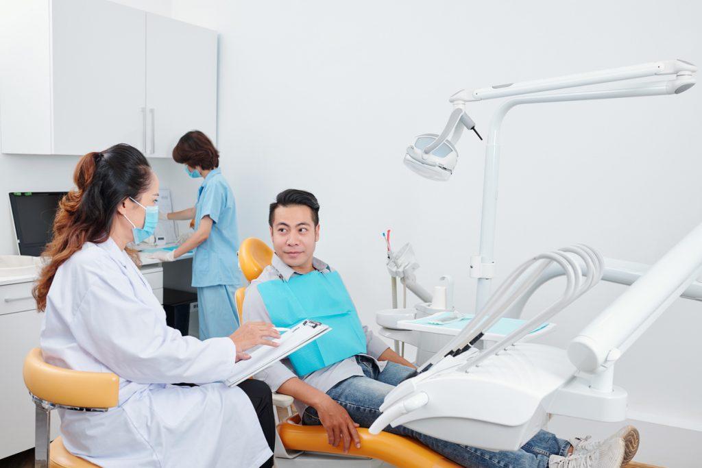 Male patient consulting with dentist